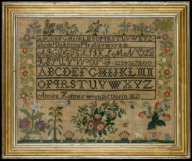 A sampler with four full alphabets in different styles and "Almira Holmes wrought this in 1821", all surrounded by polychrome floral embroidery.