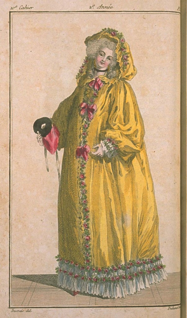 A woman in a yellow domino, which is something like a hooded muumuu.